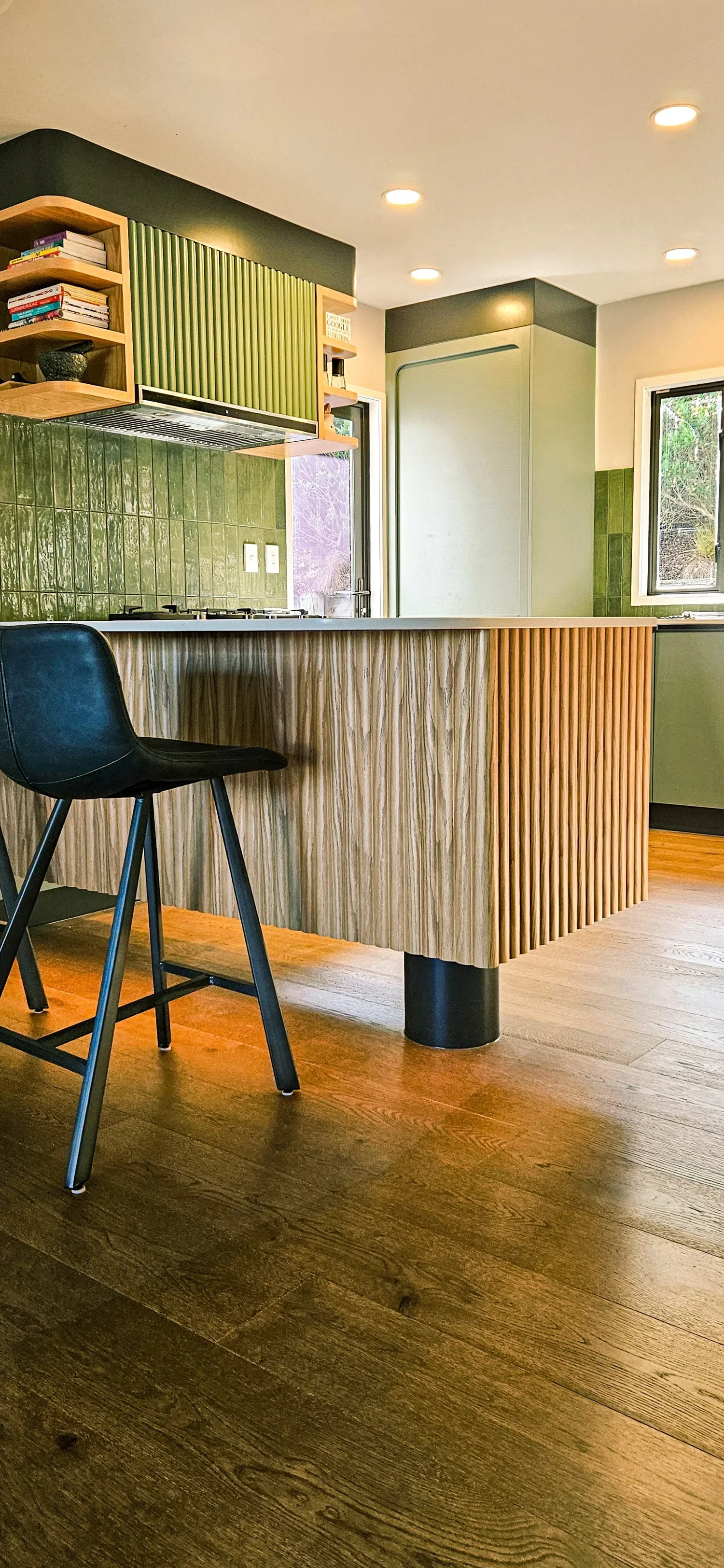 Warm timber floors, bespoke cabinetry and a fluted kitchen island